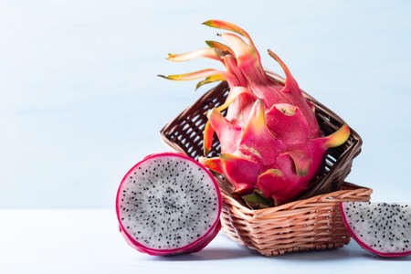 Fresh dragon fruit or pitaya in basket on color background, Tropical fruitの写真素材
