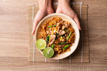 Thai food (Pad See Ew), Stir fried rice noodles with soy sauce, egg, kale and pork, Table top viewの写真素材