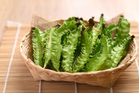 Winged bean in bamboo basket, Organic vegetable from local market in Southeast Asia