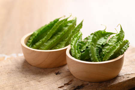 Winged bean in wooden bowl, Organic vegetable from local market in Southeast Asia