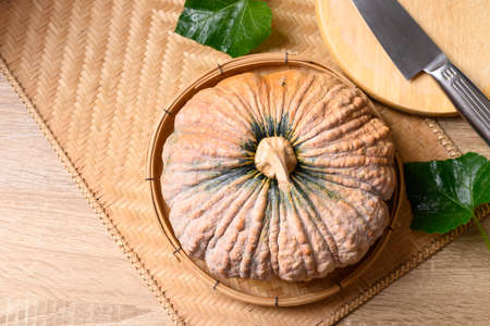 Asian pumpkin with kitchen knife prepare for cooking