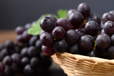 Close up of red grape in bamboo basketの写真素材