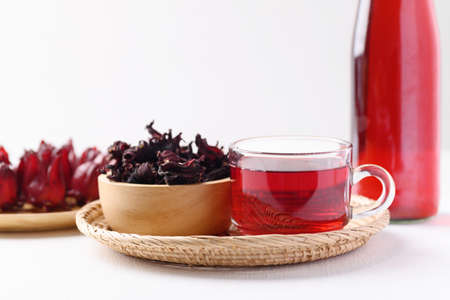 Roselle tea in glass and bottle on white background, Healthy herbal drinkの写真素材