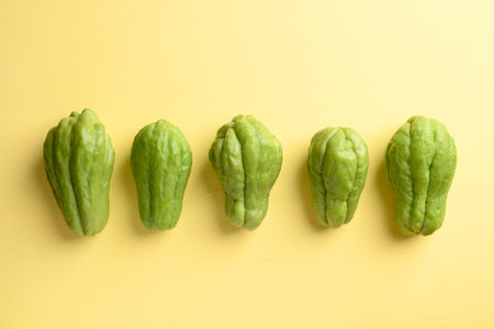Chayote squash fruit on yellow, Organic vegetables from local marketの写真素材