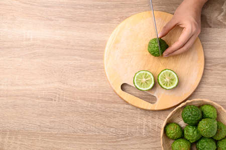 Kaffir lime or bergamot cutting on wooden board, Table top viewの写真素材