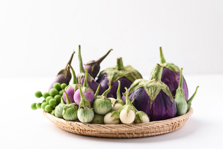 Various eggplant or aubergine in basket on white background, Organic vegetablesの写真素材