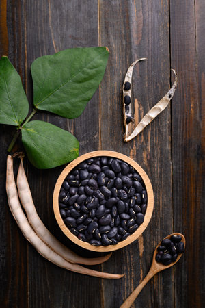 Black kidney bean seed in bowl on wooden background, Table top view