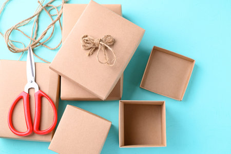 Handmade paper gift box on light blue color background, Craft present for giving in special day and holidayの写真素材