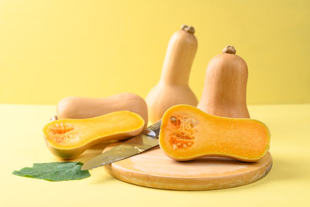 Butternut squash or butternut pumpkin on yellow background, vegetable in autumn season