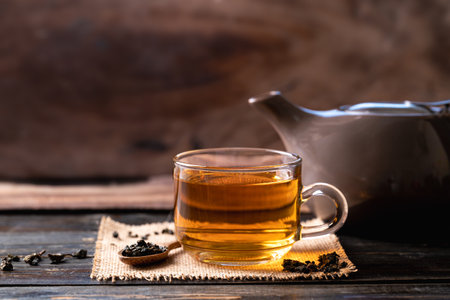 Hot tea in cup glass and teapot on wooden background, Healthy drinkの写真素材