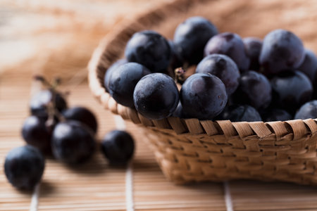 Black grape in bamboo basket, Healthy fruitの写真素材