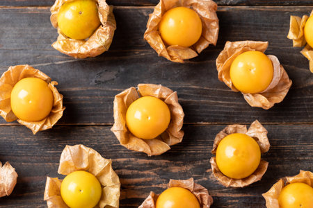 Cape gooseberry or golden berry (Physalis peruviana) on wooden background, Table top viewの写真素材