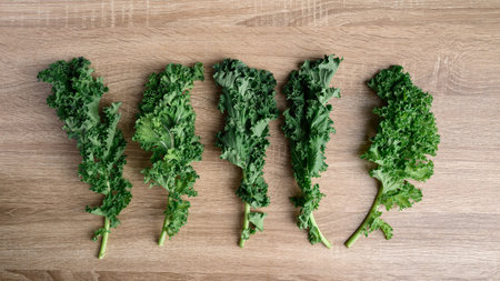 Green Kale or leaf cabbage on wooden background, healthy vegetable