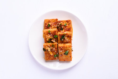 Korean side dish, spicy braised tofu (Dubu Jorim) on white background