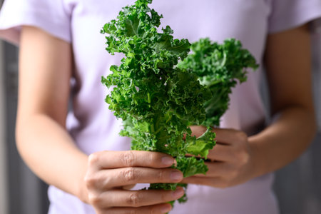 Green Kale or leaf cabbage in woman hand, Healthy vegetable