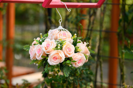Artificial pink roses flower bouquet hanging and decoration in gardenの写真素材