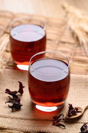 Roselle tea in glass with dried roselle, Herbal drink for reduction in blood pressureの写真素材