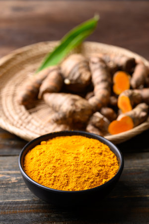 Turmeric powder and fresh turmeric (Curcuma, curcumin), Organic ingredient in Asian cuisine, food coloring or natural dyeingの写真素材