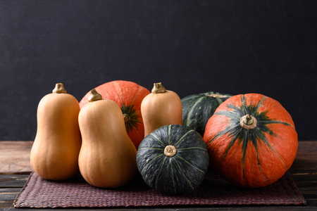 Pumpkin and butternut squash on wooden table with black background, Organic vegetable in Autumn seasonの写真素材