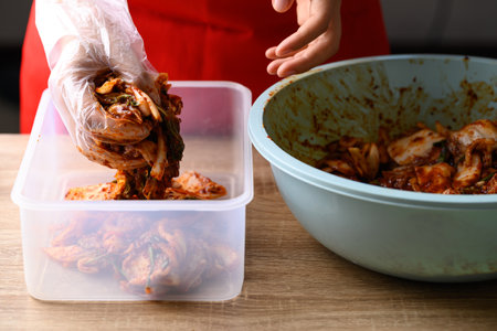 Korean food, Kimchi cabbage cooking with hand, Homemade fermented side dishの写真素材