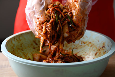 Korean food, Kimchi cabbage cooking with hand, Homemade fermented side dishの写真素材
