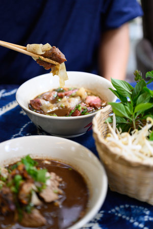 Rice noodles soup with pork, beef and vegetables, Thai boat noodles styleの写真素材