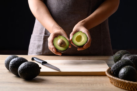 Ripe hass avocado fruit in hand prepare for cooking, Healthy fruit