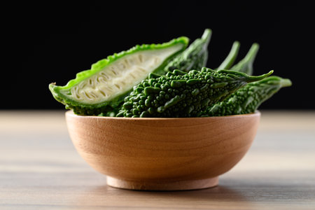 Bitter gourd or bitter melon in wooden bowl, Asian food ingredients and herbal medicine