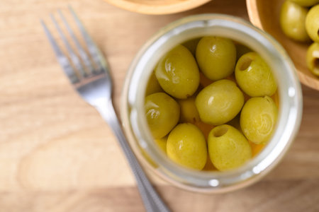 Pickled olives, Pitted green olives in glass jar, Table top viewの写真素材