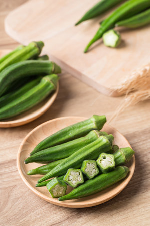Green okra in wooden bowl prepare for cooking, Organic vegetables