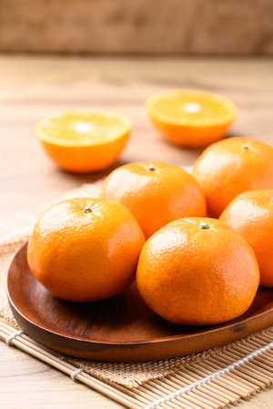 Mandarin orange fruit on wooden plate, Tropical fruitの写真素材