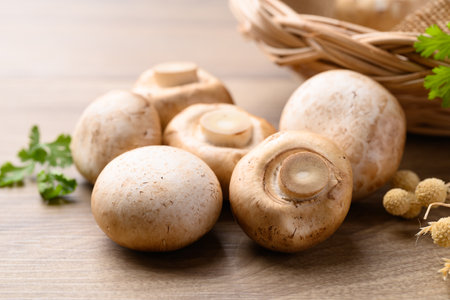 Fresh Champignon mushroom on wooden backgroundの写真素材