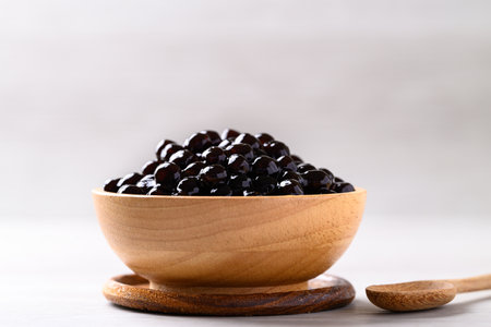 Black tapioca pearls or boba in wooden bowl, Ingredient in bubble tea