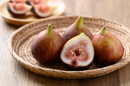 Fresh fig in natural basket on wooden background, Healthy fruitの写真素材
