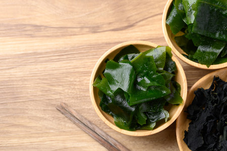 Fresh Wakame seaweed or sea mustard in wooden bowl, Table top view