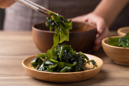 Wakame seaweed or sea mustard salad with chopsticks, Healthy eatingの写真素材