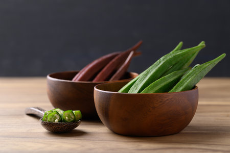 Fresh green and red okra in wooden bowl, Organic vegetable, Food ingredient