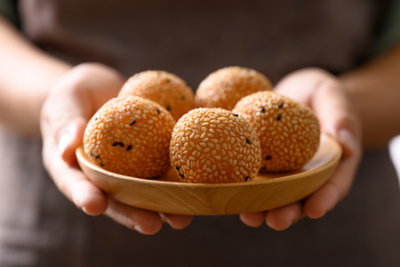 Sesame ball, Fried glutinous rice flour coated with sesame seeds and filled with mung bean, red bean paste or sweet coconutの写真素材