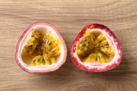 Half passion fruit on wooden background, Table top viewの写真素材