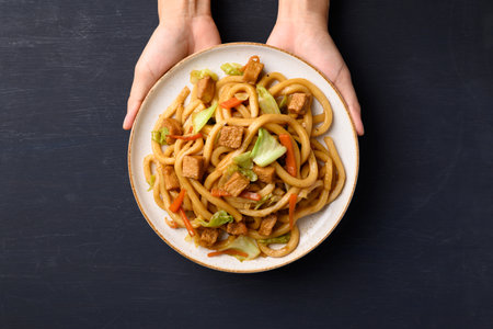 Yaki Udon, Stir fried udon noodles with tofu, carrot, cabbage and mushroom, Japanese cuisine, Asian vegetarian foodの写真素材