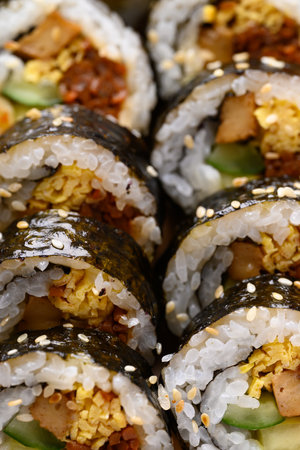 Gimbap or kimbap, Korean food made from cooked rice with vegetables, meat, egg and wrapped with dried seaweedの写真素材