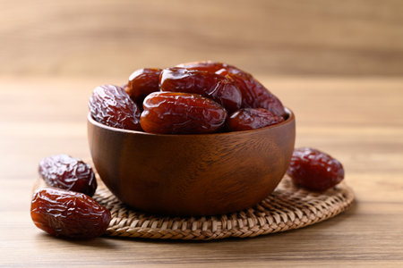 Date palm fruit (MedJool) in wooden bowl