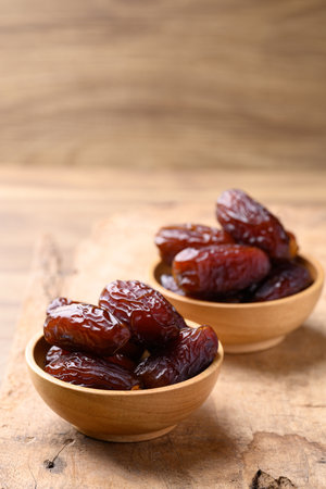 Date palm fruit (MedJool) in wooden bowl