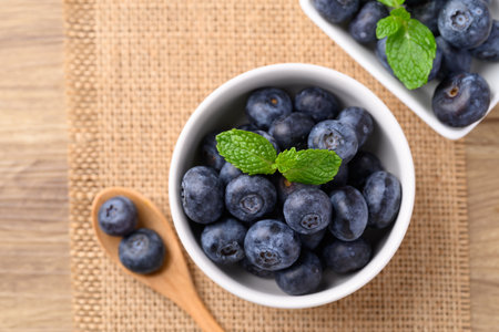 Blueberries in bowl with spoon, Healthy fruit, Food ingredient, Table top viewの写真素材