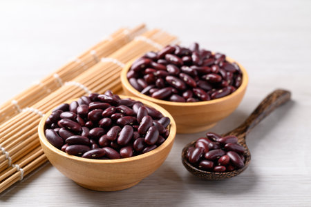 Red kidney beans in wooden bowl and spoon on white background, Food ingredientの写真素材