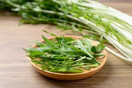 Mizuna, Water green, Japanese mustard green on wooden plateの写真素材