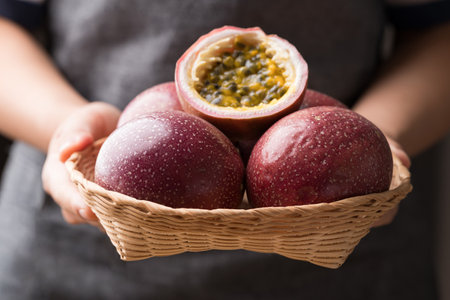 Fresh passion fruit in basket holding by hand, Tropical fruitの写真素材