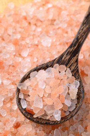 Organic Himalayan pink salt in wooden spoon, Healthy food ingredientの写真素材