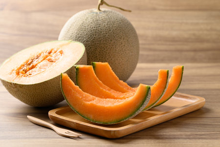 Sliced Orange melon, Musk melon or Flesh melon on wooden plate ready to eating, Fruit in summer seasonの写真素材