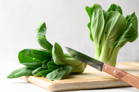 Organic Bok choy or Pak choi on cutting wooden board with kitchen knife, Fresh vegetable, Food ingredientの写真素材